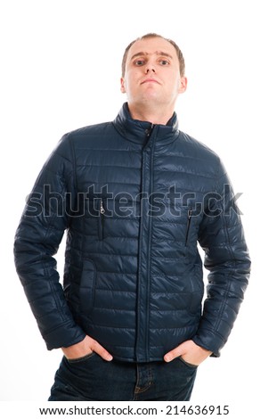 Attractive young guy posing in studio. serious young man in winter or autumn clothes looking at the camera. Cheerful smiling man in winter clothes isolated on white background