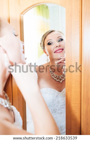 Beautiful bride is getting ready in the morning. adorable bride is getting ready in the morning. Portrait of beautiful woman in white dress