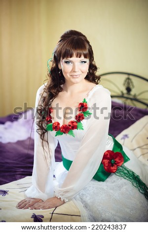 Portrait of ukrainian bride getting ready in the morning. Beautiful caucasian bride in national ukrainian clothes getting ready for the wedding ceremony.
