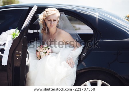 Portrait of a pretty bride in a car.  close-up portrait of a pretty shy bride in a car window.