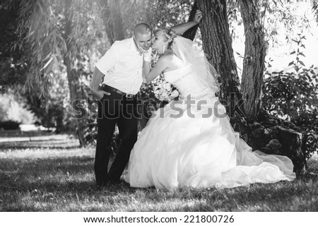 Happy young bride and groom outdoors in the park on their wedding day. Wedding couple - new family! wedding dress. Bridal wedding bouquet of flowers