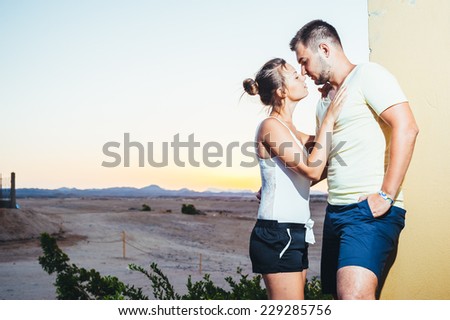 romantic couple during tropical vacation. Romantic Wedding Couple hugging on the tropical Beach at Sunset. Love story