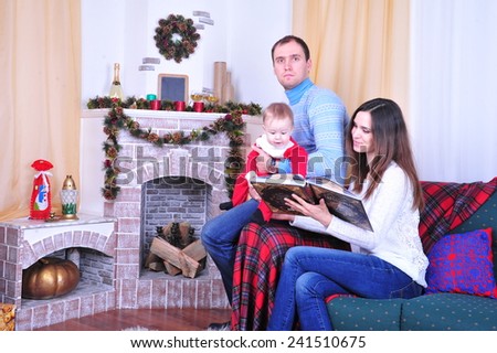 Family sitting together near fireplace in Christmas interior. Happy family having fun with Christmas presents. Christmas Family Portrait, Mother, Father And Son Celebrate Holiday, Opening Gift Box