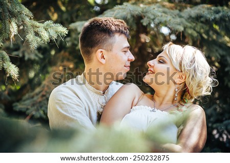 Happy bride and groom on their wedding. Groom and Bride in a park. wedding dress. Bridal wedding bouquet of flowers