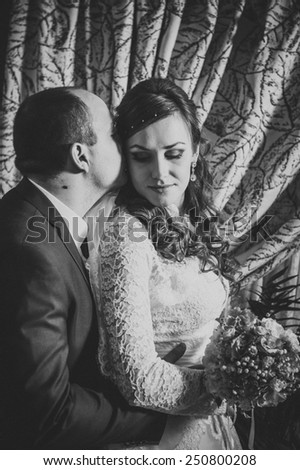 Charming bride and groom on their wedding celebration in a luxurious restaurant. Black and White vintage photo. Contains film grain!