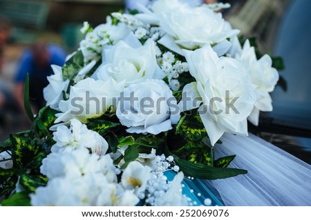 wedding car decorated with flowers and ribbons