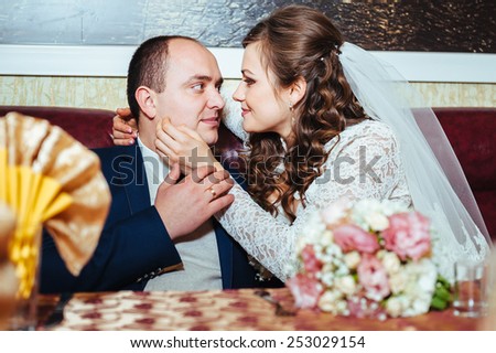 Charming bride and groom on their wedding celebration in a luxurious restaurant.