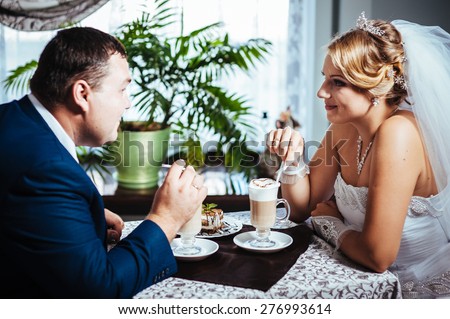 Hands of bride and groom. Cappuccino or latte coffee with heart shape. bride and groom drink a cup of Coffee latte on the date. Happy bride and groom drink a cup of Coffee latte with heart design.