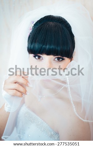 Bride getting ready. beautiful bride in white wedding dress with hairstyle and bright makeup. Happy sexy girl waiting for groom. Romantic lady in bridal dress have final preparation for wedding.