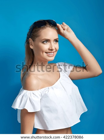 Similar – Image, Stock Photo Young dimpled woman smiles and looks at camera while standing in front of petrol blue wall