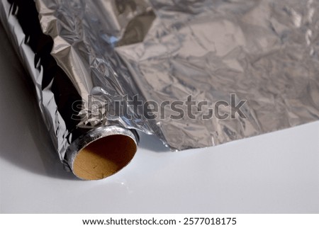 Similar – Image, Stock Photo aluminum foil, rolled aluminum foil, close-up on a black background,