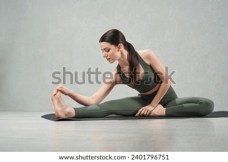 Similar – Image, Stock Photo Focused sportswoman hanging on bar while working out in gym