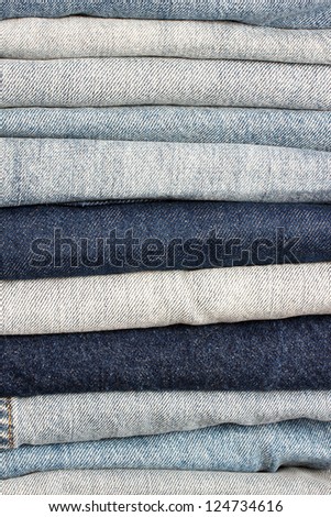 Pile of different shades of blue jeans