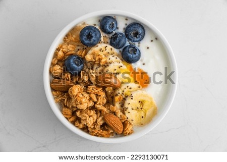 Similar – Image, Stock Photo Healthy breakfast. Bowl with cereals, raspberries and blueberries next to oranges