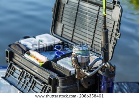 A large fisherman's tackle box fully stocked with lures and gear for fishing.fishing lures and accessories. fishing spinning. Kit of fishing lures.