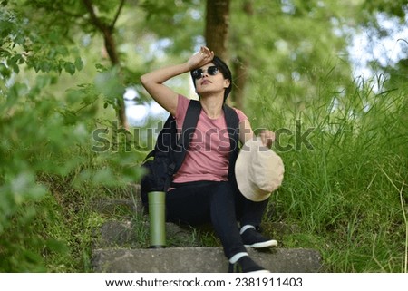 young lady walking in the forest, drinking water, taking photos Stok fotoğraf © 