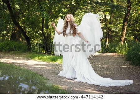 Free Beautiful blonde girl in white dress wearing huge white angel ...