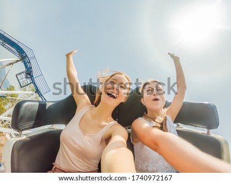 Two happy girls having fun on rollercoaster ストックフォト © 