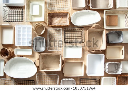 Flat lay of Marie Kondo's storage boxes, containers and baskets with different sizes and shapes for tidying up wardrobe. KonMari method organizer boxes set. Closet organizing concept.
