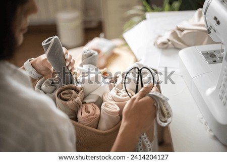 Similar – Image, Stock Photo Closeup of female tailor cuting out checkered fabric with a paper pattern to make out a shirt