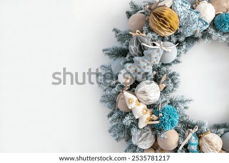 Similar – Image, Stock Photo Christmas composition. Wreath made of fir tree branches and festive pine cones on a red background, top view