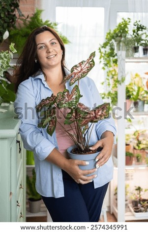 Similar – Image, Stock Photo woman gardener posing with bouquet of astilbe flowers in private garden. Country living and landscape design concept