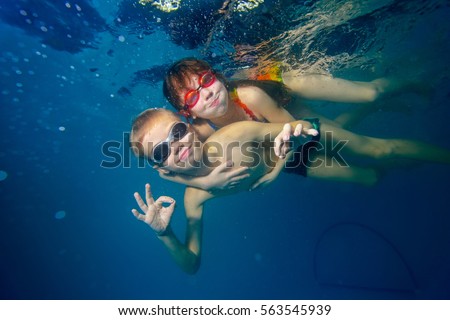 Similar – Image, Stock Photo Funny boy swimming underwater looking at camera