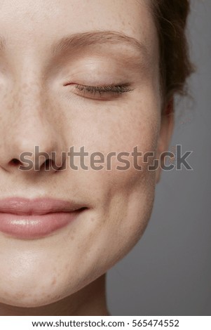 Similar – Image, Stock Photo Young dimpled woman smiles and looks at camera while standing in front of petrol blue wall