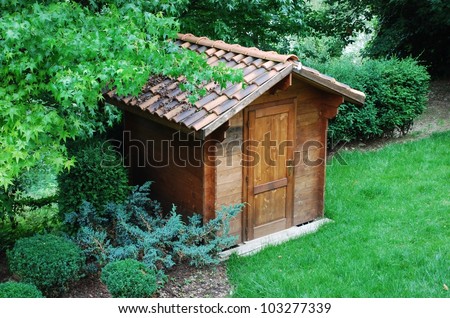 Wooden garden tool shed in a beautiful park