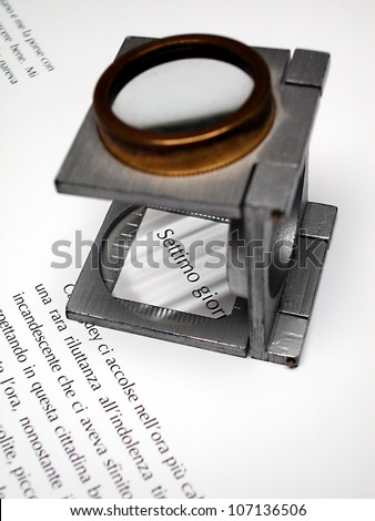 Detail of text and loupe lens on an offset printed sheet