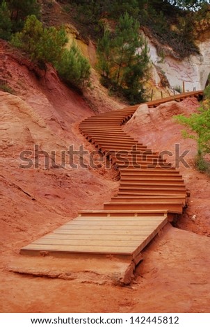 The red ocher walk with wooden stairs in Roussillon, Provence, France