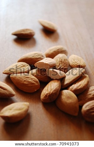 Shelled almonds on natural wooden table background