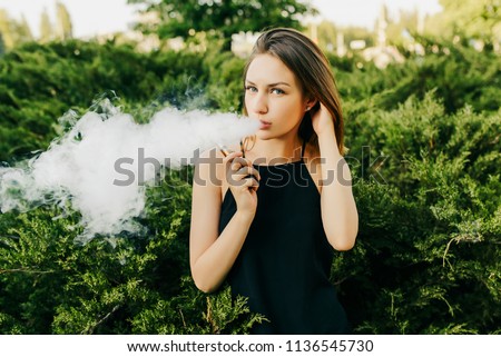 Similar – Image, Stock Photo Modern relaxed woman vaping while sitting on marked road