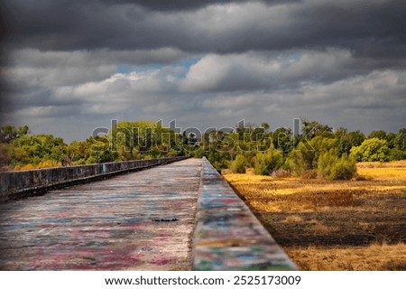 Similar – Image, Stock Photo Graffiti on a bridge: “Stop consuming”. Seen in Berlin / Photo: Alexander Hauk