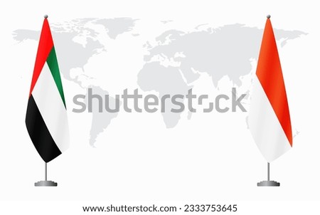 United Arab Emirates and Indonesia flags for official meeting against background of world map.