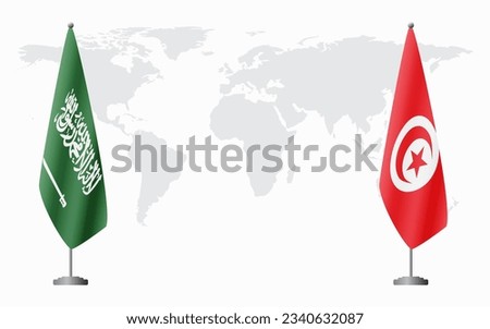 Saudi Arabia and Tunisia flags for official meeting against background of world map.