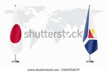 Japan and Saint Martin flags for official meeting against background of world map.