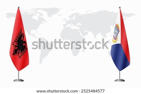 Albania and Sint Maarten flags for official meeting against background of world map.