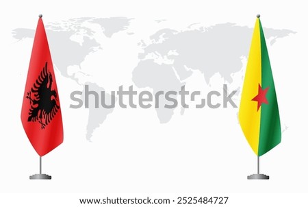 Albania and French Guiana flags for official meeting against background of world map.