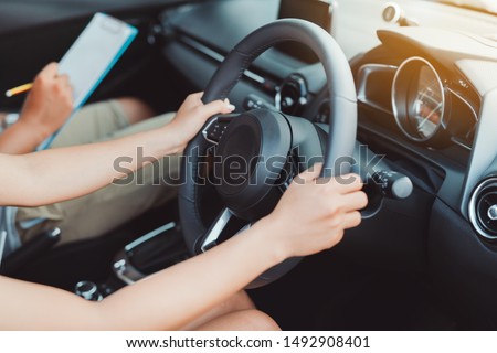 Woman practice driving car exam driver licence control steering wheel education and learn on street road by driving instructor teaching at school drive transportation safety travel, people lifestyle 商業照片 © 