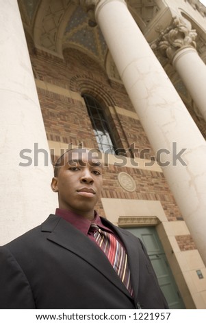 Low angel view of a business man in front of pillars
