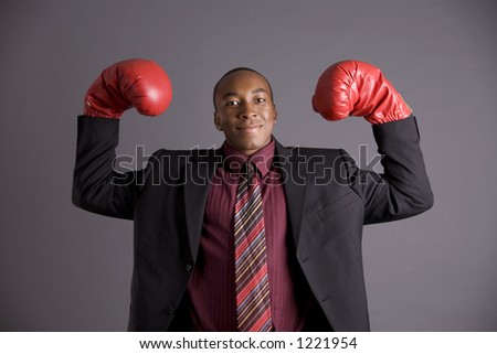 business man dancing around in boxing gloves