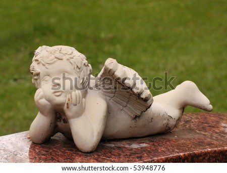 cherub baby in cemetery - lying down, on base