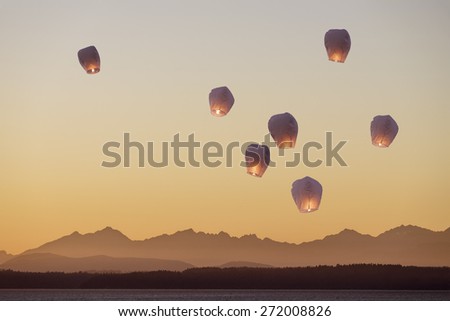 A group of flying lanterns being released into the nightsky