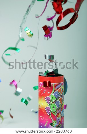 Colored confetti shooting up in the air from a party popper
