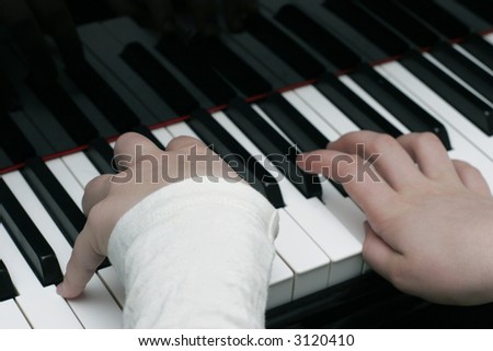 Kid playing the piano during piano lesson