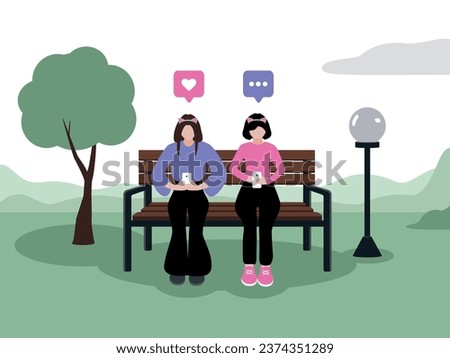 Two girls with cat ears with light skin of European appearance in fashionable clothes are sitting in smartphones in the park on a bench next to a tree and a lantern