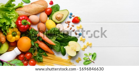 Healthy food background. Food photography different fruits and vegetables on white wooden table background. Copy space. Shopping food in supermarket
