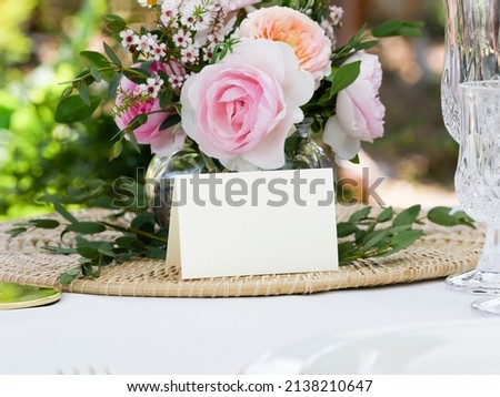 Image, Stock Photo Wedding Table place with a card over envelope near flowers and feathers, mockup