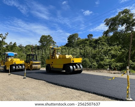 Similar – Foto Bild Arbeiter mit Asphaltfertigerwerkzeug beim Straßenbau.